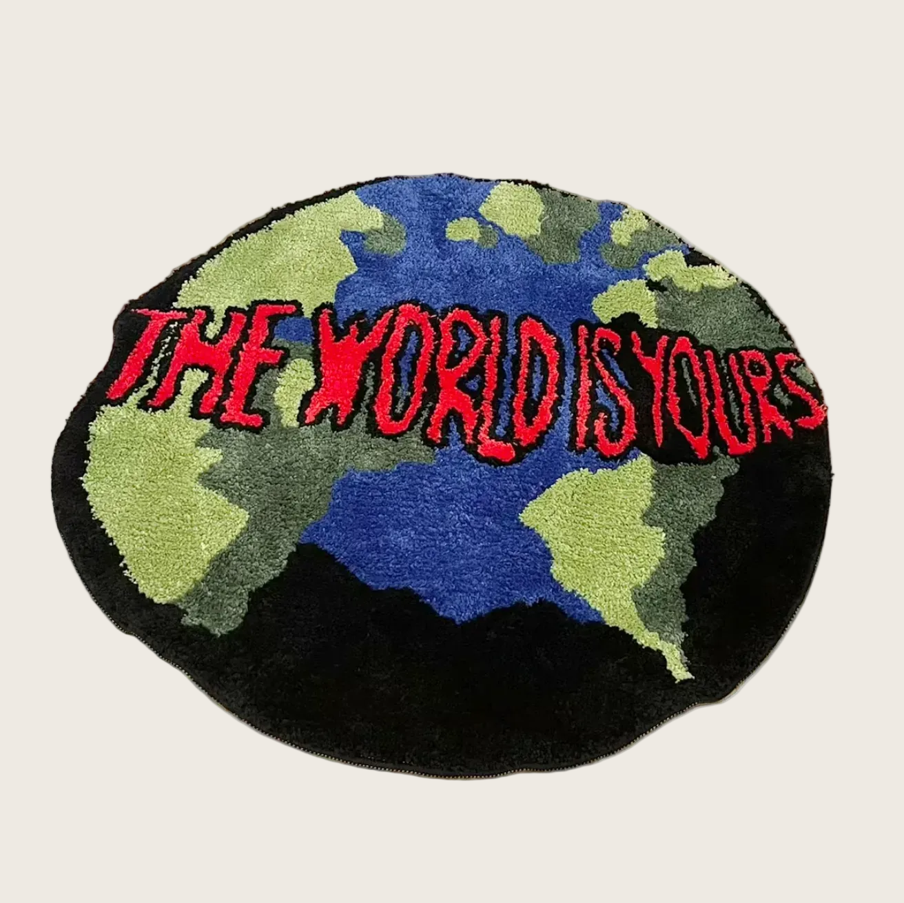Round rug with 'The World is Yours' text on a wooden floor